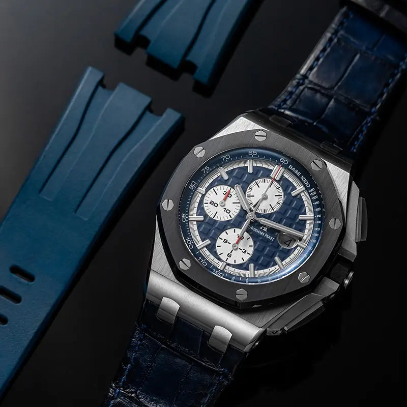 Photo of the Audemars Piguet Royal Oak Offshore 26401PO.00.A018CR.01 in platinum with blue dial, chrono subdials, and leather strap with an extra blue rubber strap