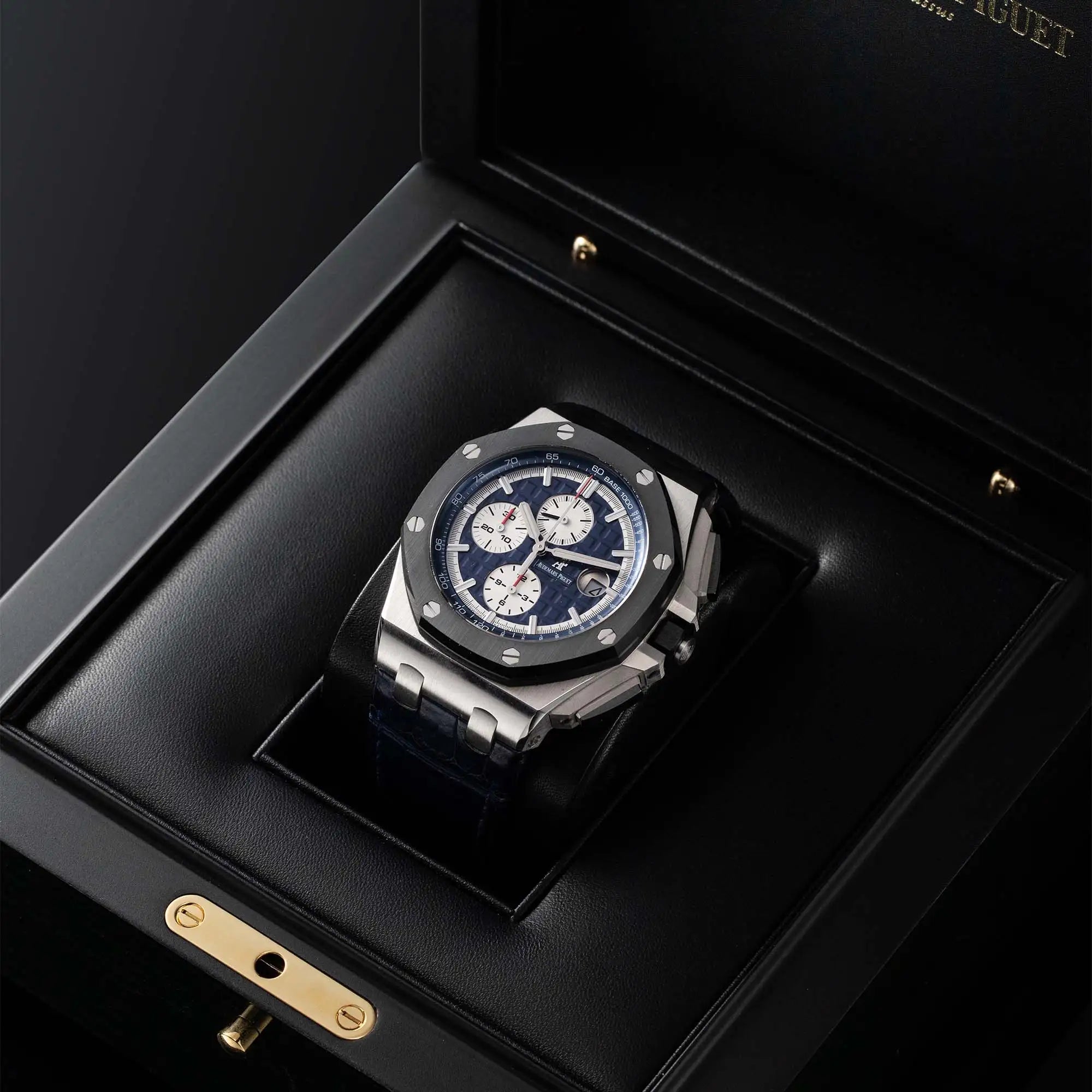 Photo of the Audemars Piguet Royal Oak Offshore 26401PO.00.A018CR.01 in platinum with blue dial, chrono subdials, and rubber strap in its original box.