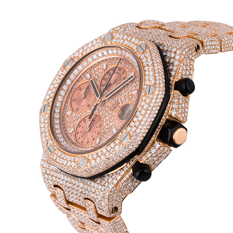 Luxury watch with rose gold case and bezel, black strap, and diamond accents on a white background