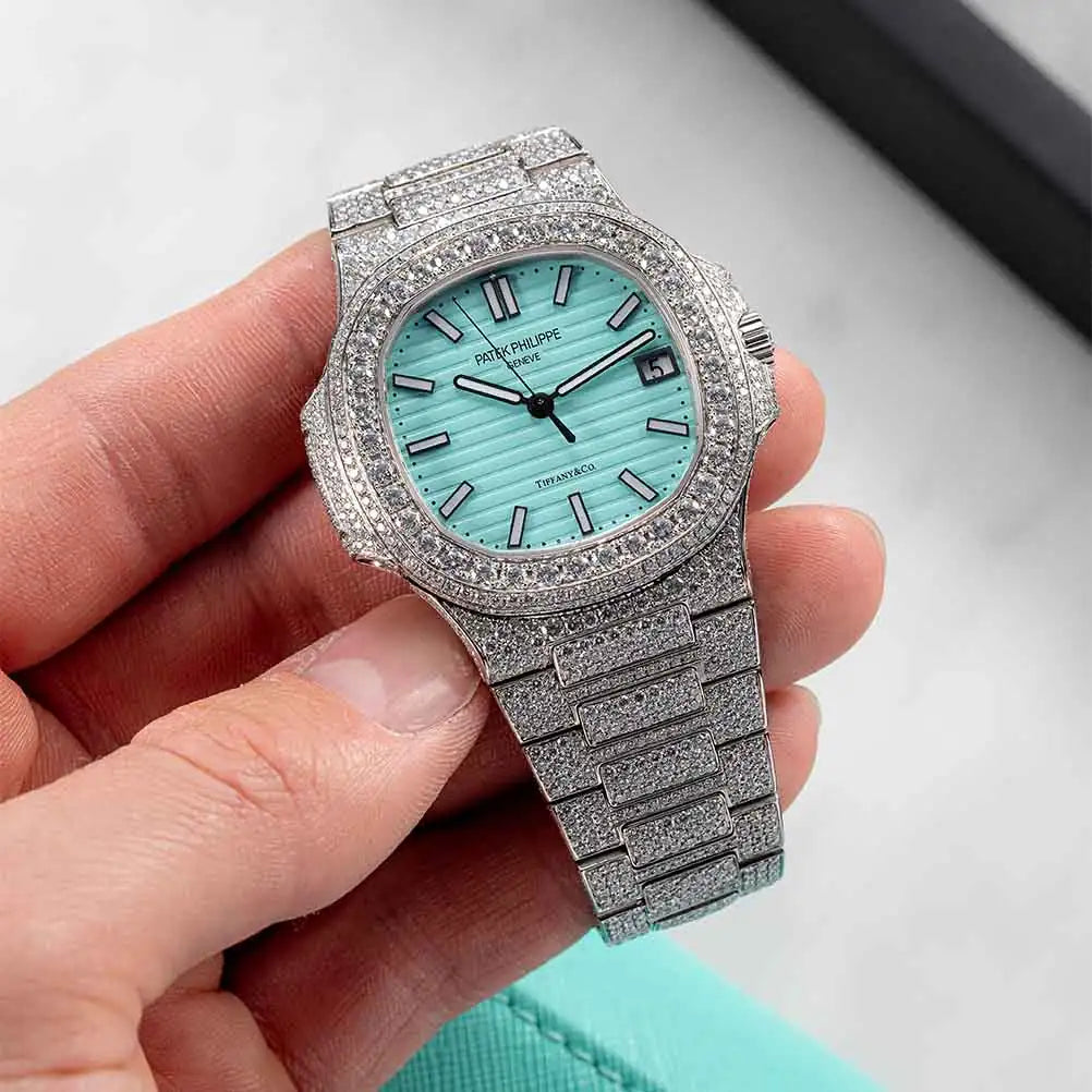 Hand holding a Patek Philippe 5711 diamond set with vs1 diamonds and a custom tiffany blue dial