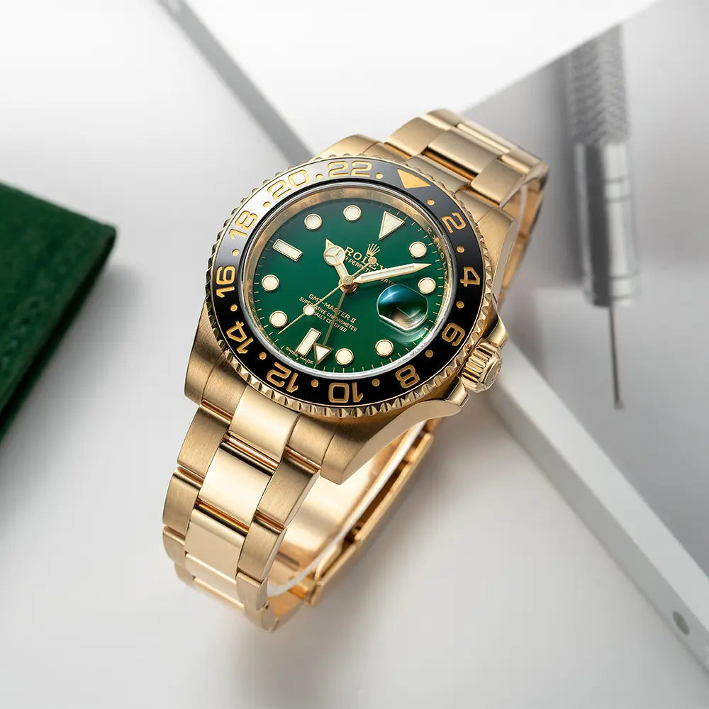 Image of the Rolex GMT-Master II in 18ct Yellow Gold with a Green Dial ref. 116718LN laying on a book and with a green pouch